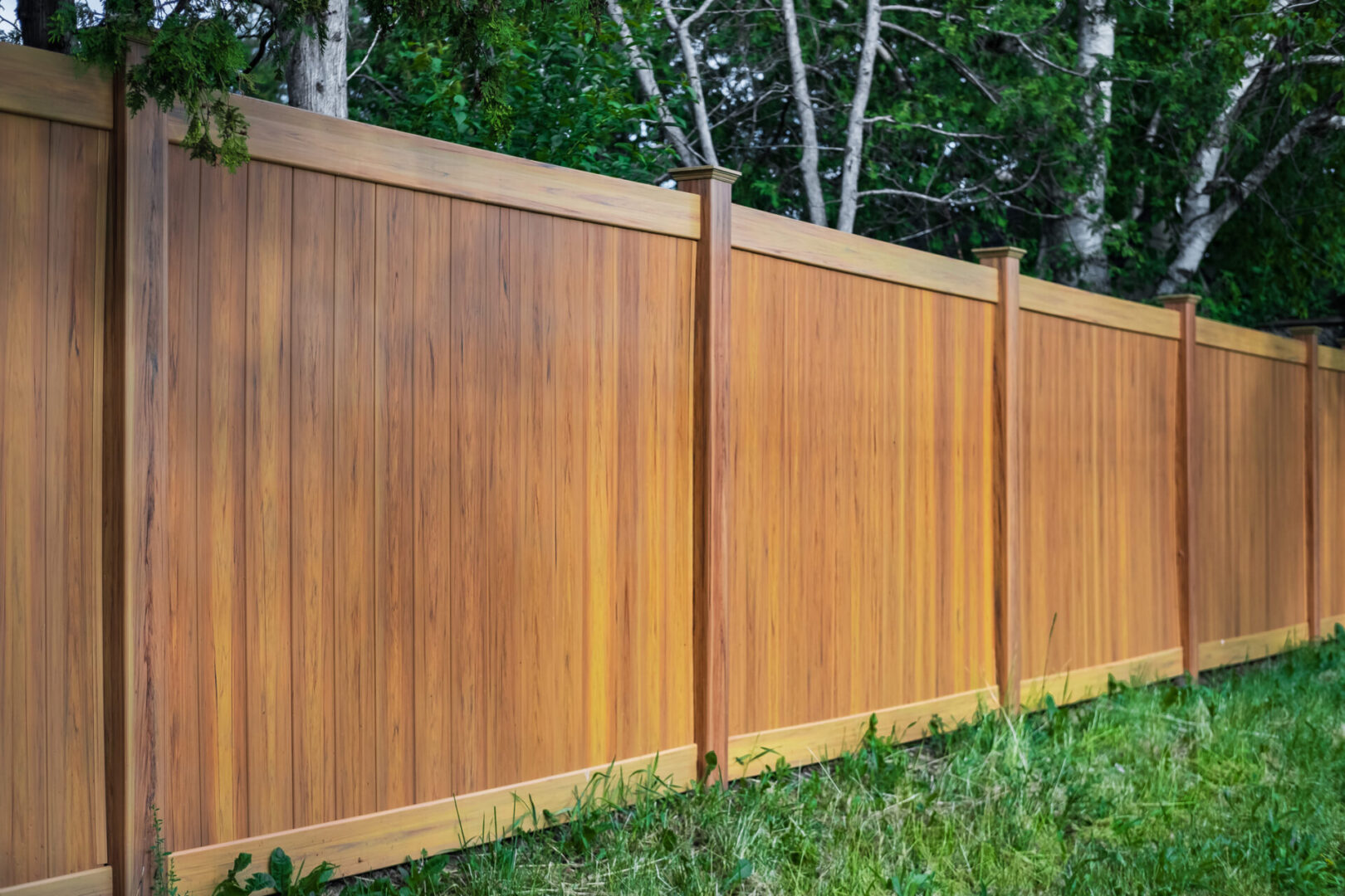 Brown fence in a grassy area