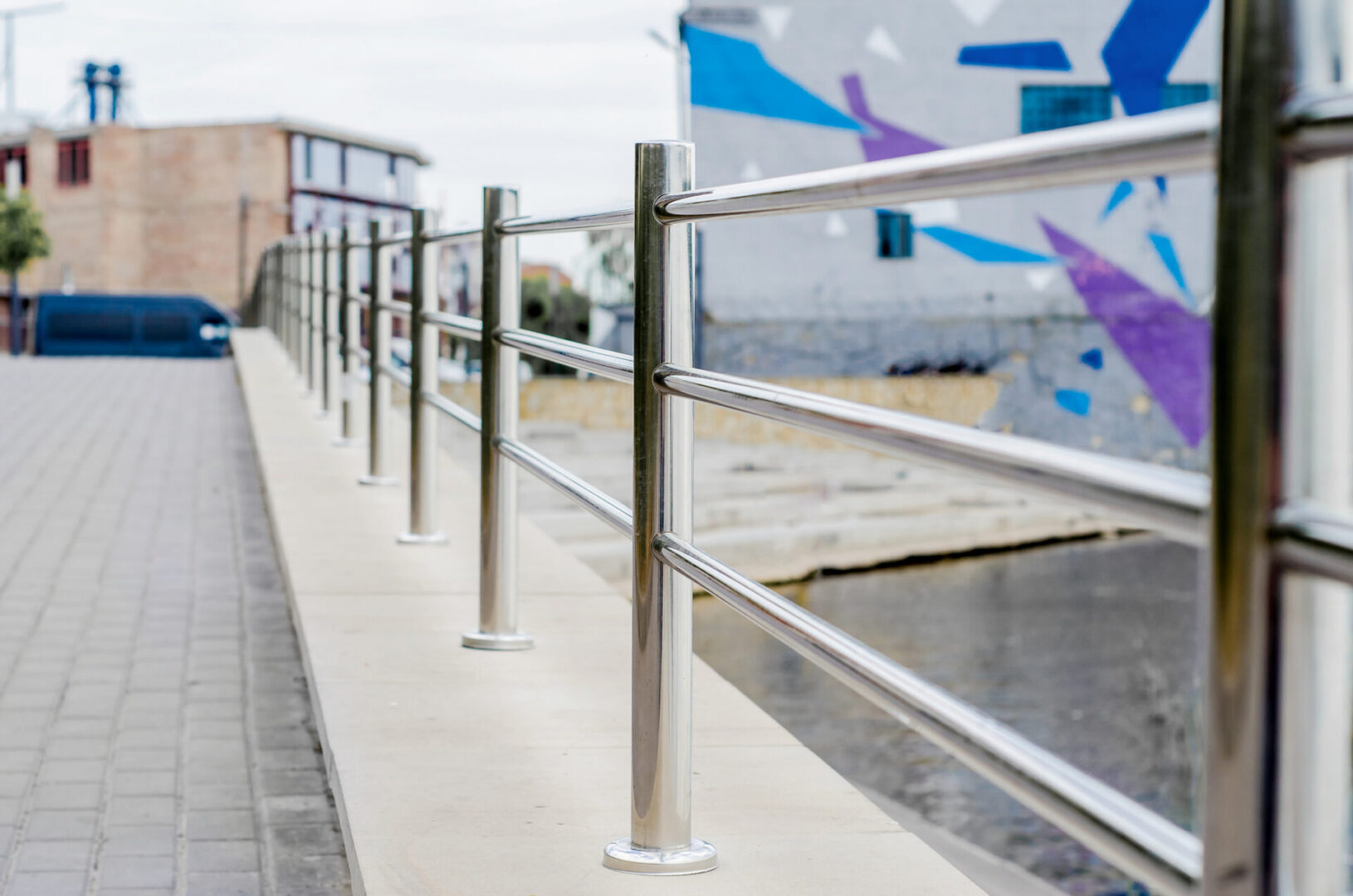 Metal railing along urban sidewalk