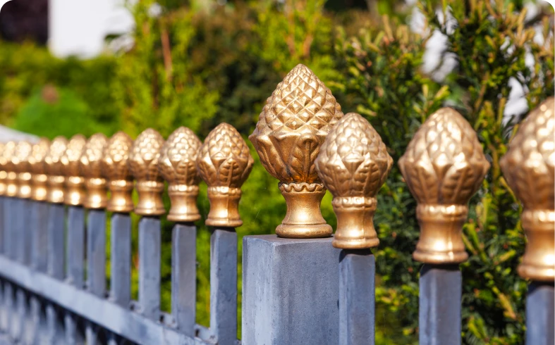 Elegant fence with gold pineapple-shaped tops